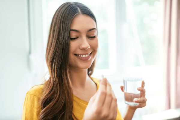 Teen Taking Probiotic supplement