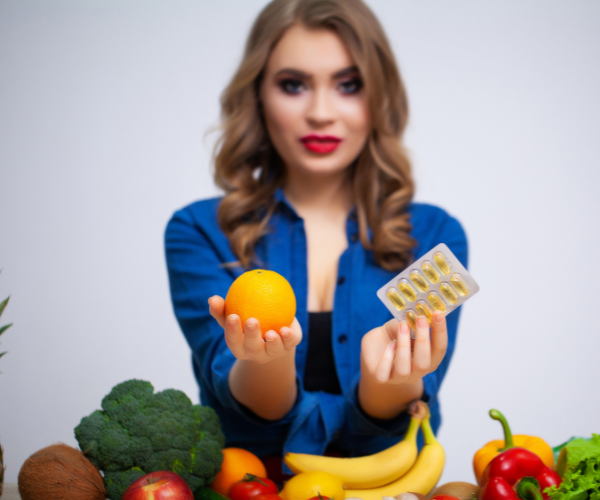 Woman choosing between food and supplements